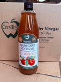 A bottle of CoralTree Organic Apple Cider Vinegar placed in front of a branded cardboard shipping box.
